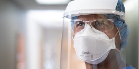 clinician using PPE equipment
