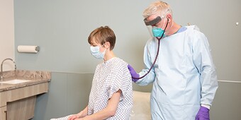 Clinician with a patient using respiratory protection
